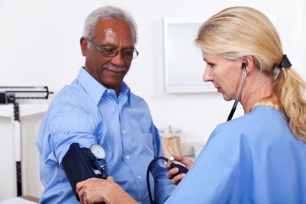 A patient having his blood pressure checked